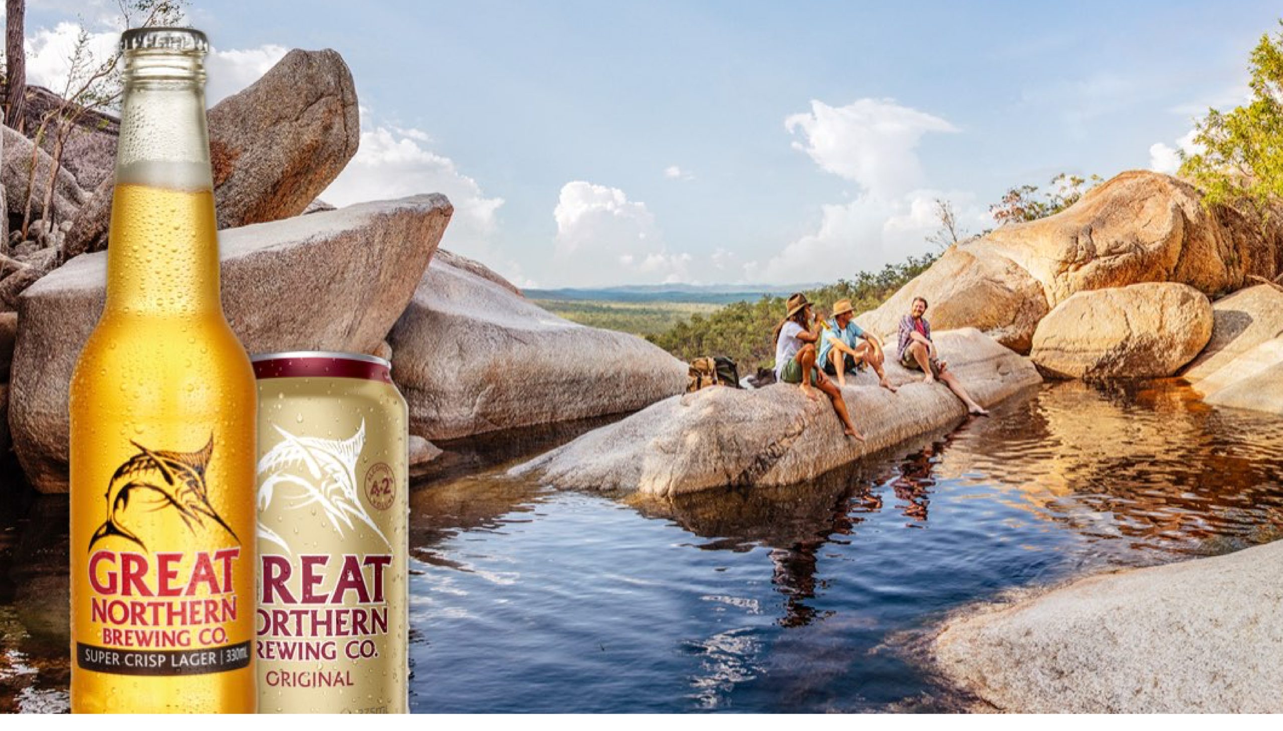 Great Northern branded beer bottle and can situated on an image of three people enjoying a relaxing afternoon by a pool of water in the Australian outback