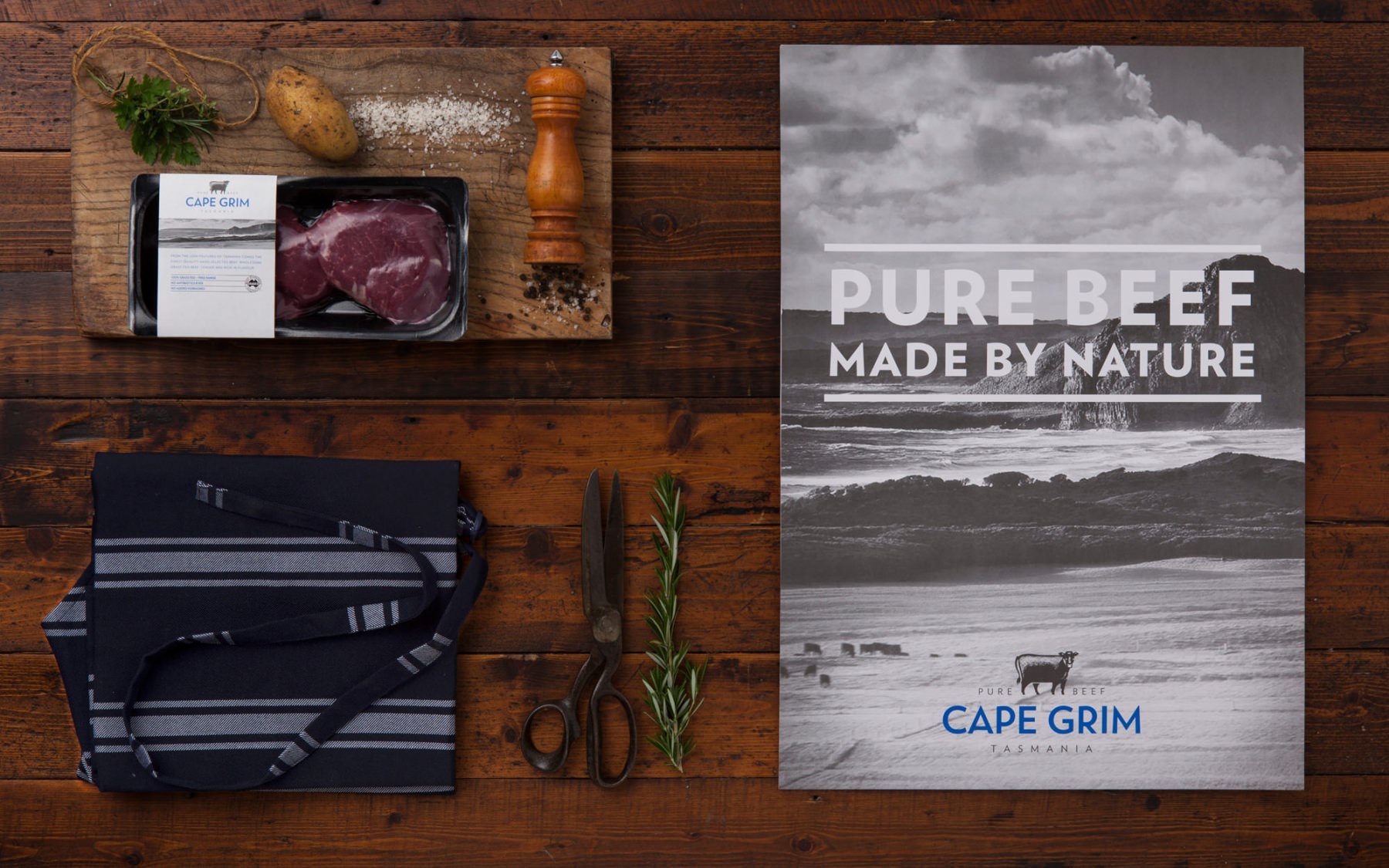 On a wooden table, the packaging for Cape Grim beef is presented, reflecting its premium quality and elegant design.