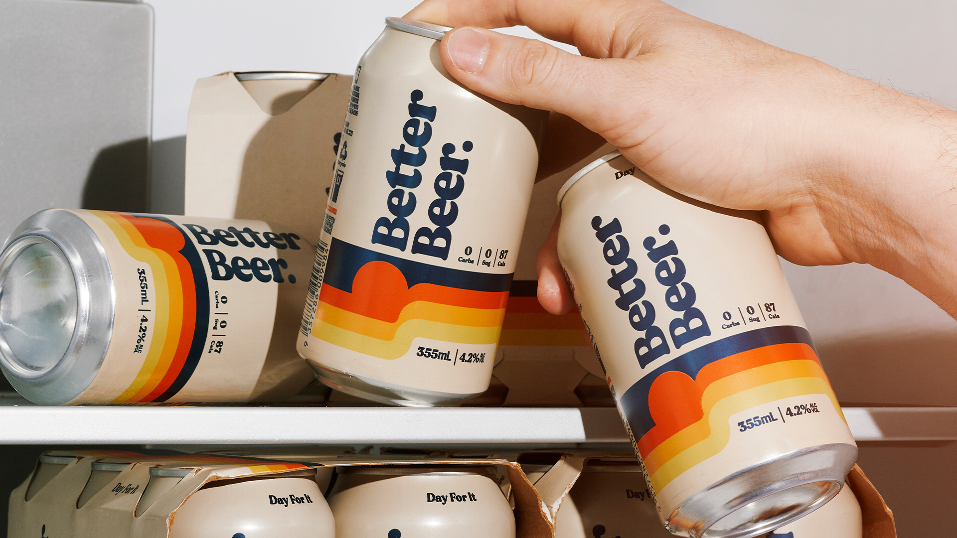 Better Beer can on fridge shelf being picked up by hand